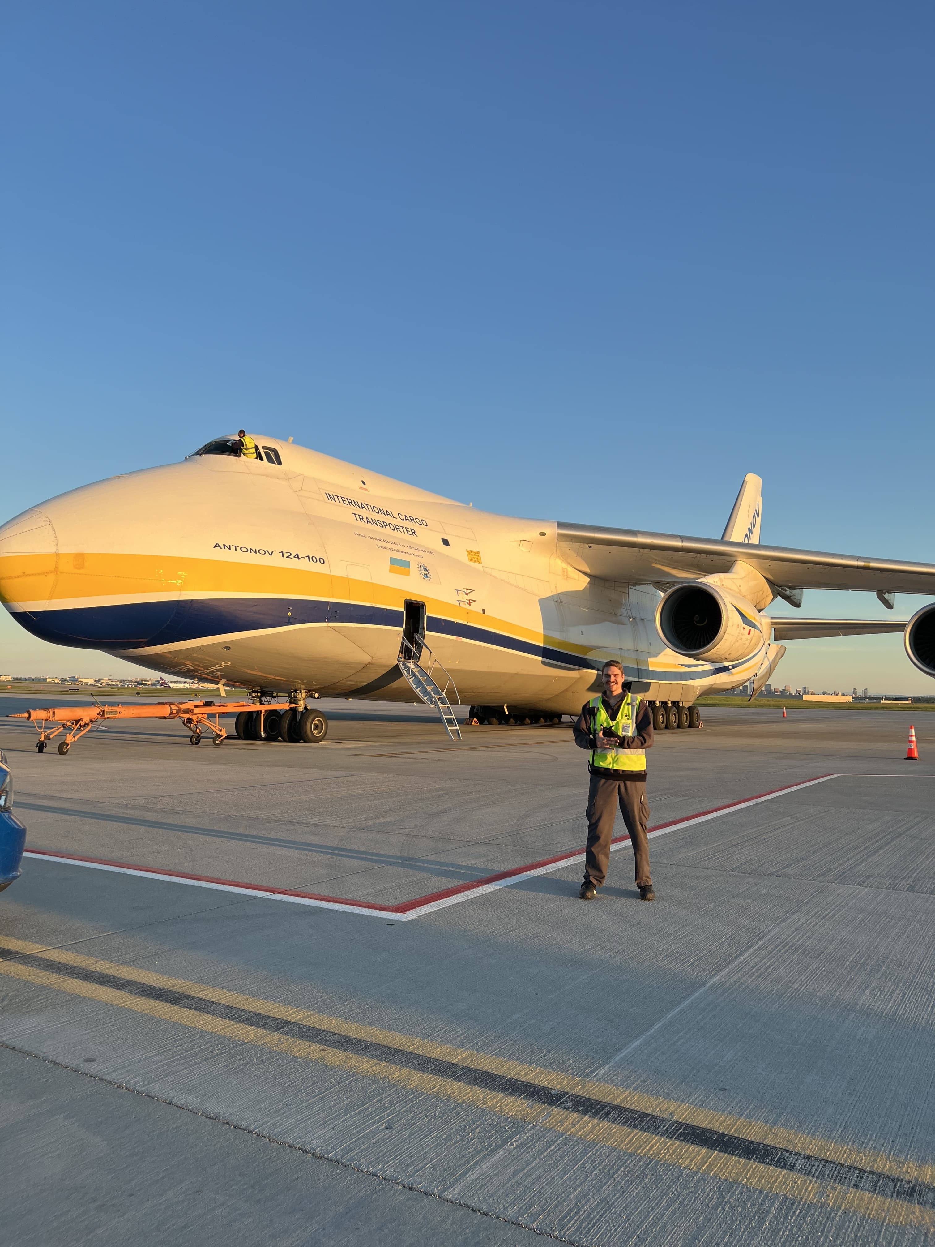 Justice Browatzke standing on an airport ramp in front of an Antonov An-124 cargo aircraft.