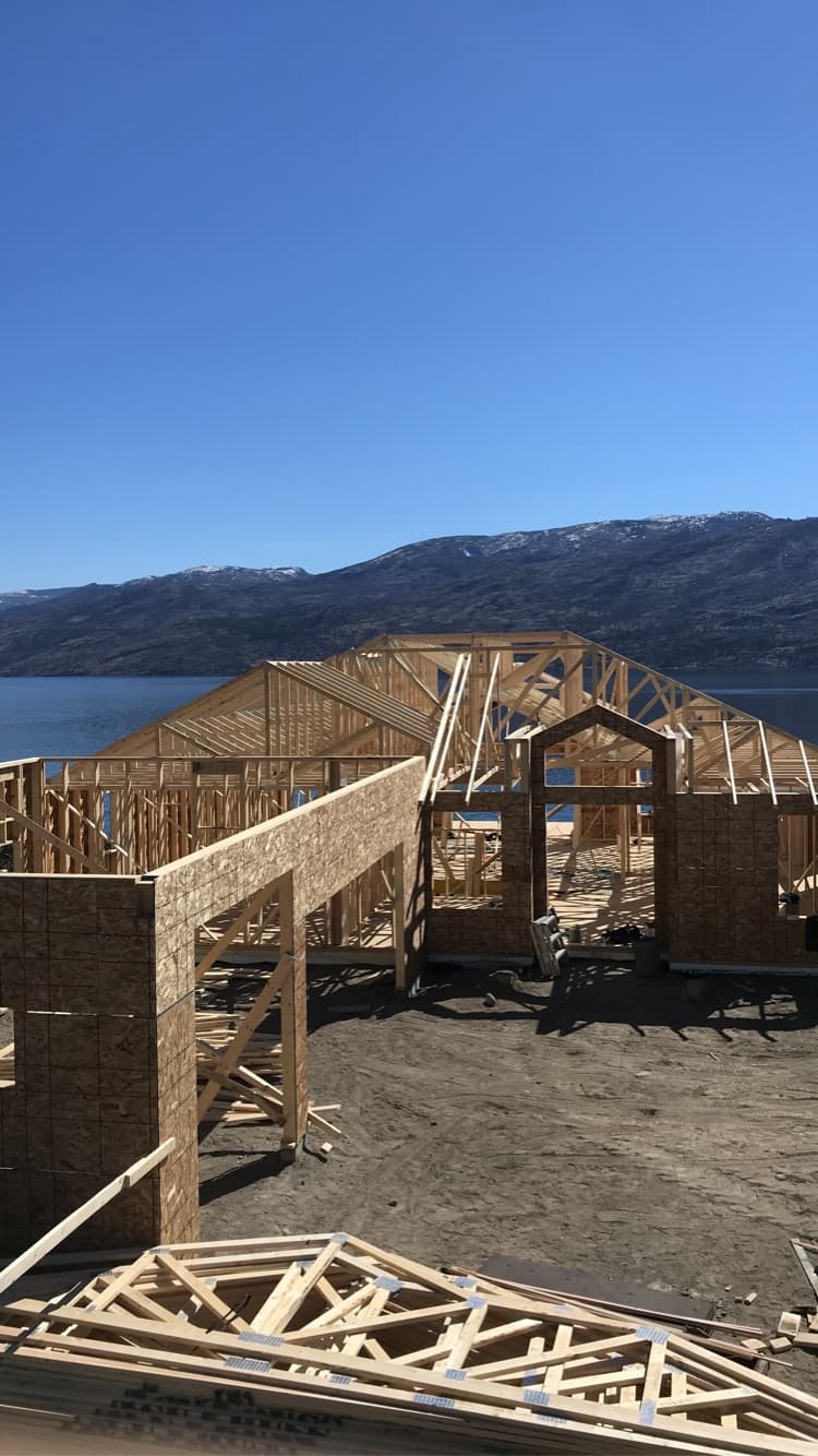 A custom wood-frame home under construction beside Okanagan Lake.